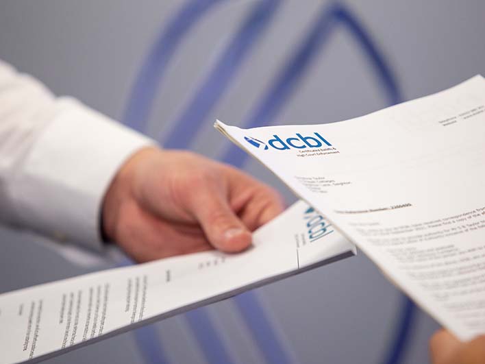 Close up of DCBL papers in hands