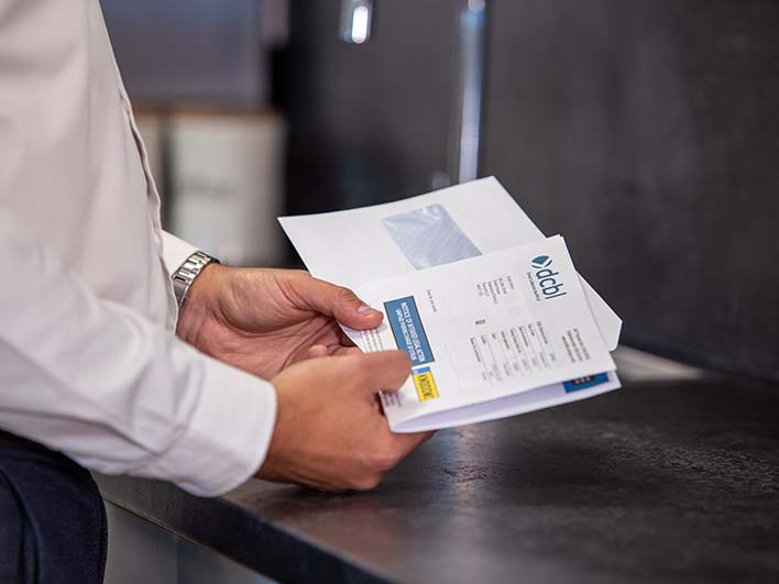Man at counter with DCBL letter