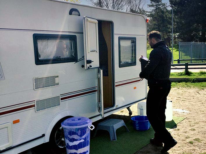 DCBL agent approaching caravan with open door