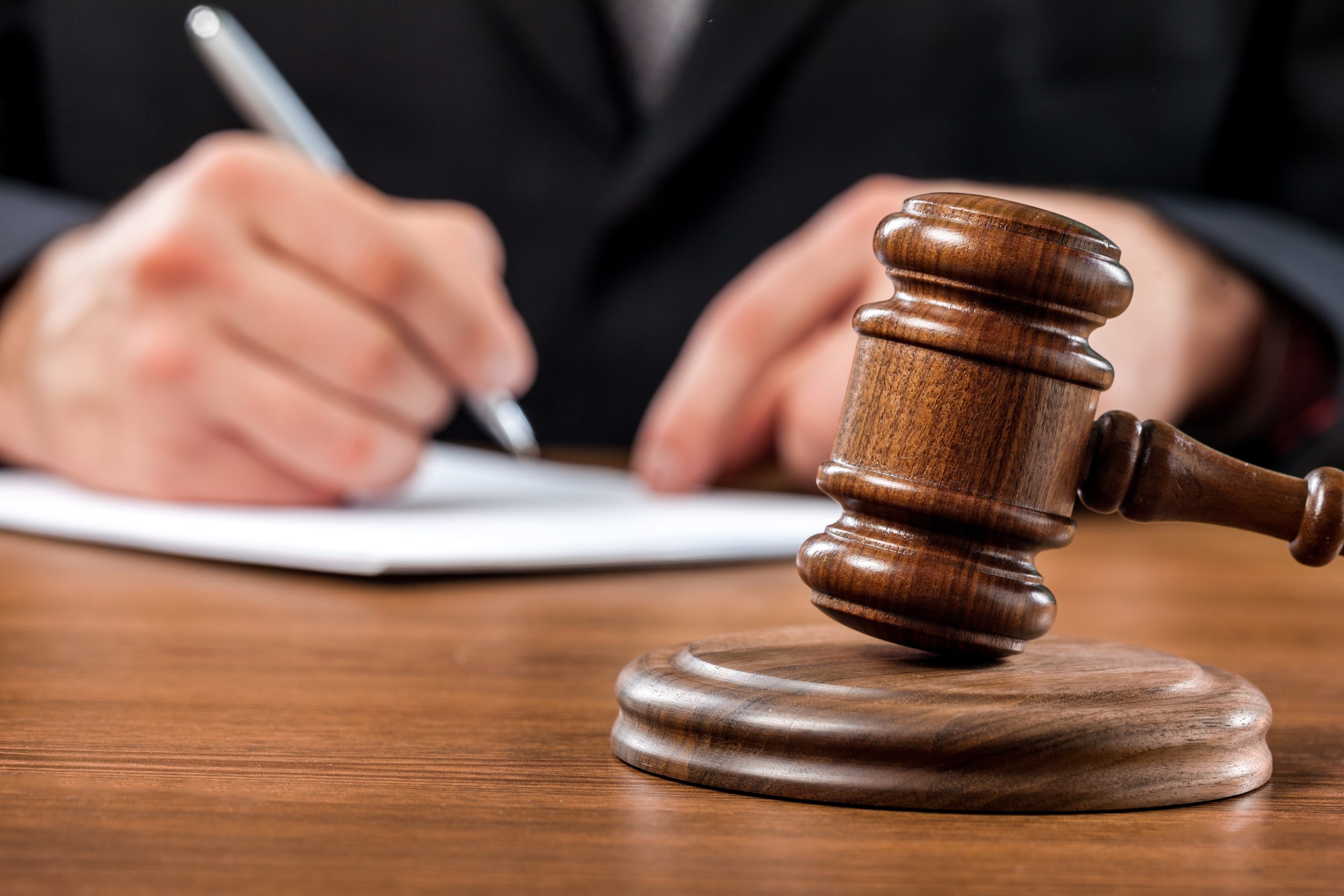 Personal CCJ wooden judges hammer with person writing in the background